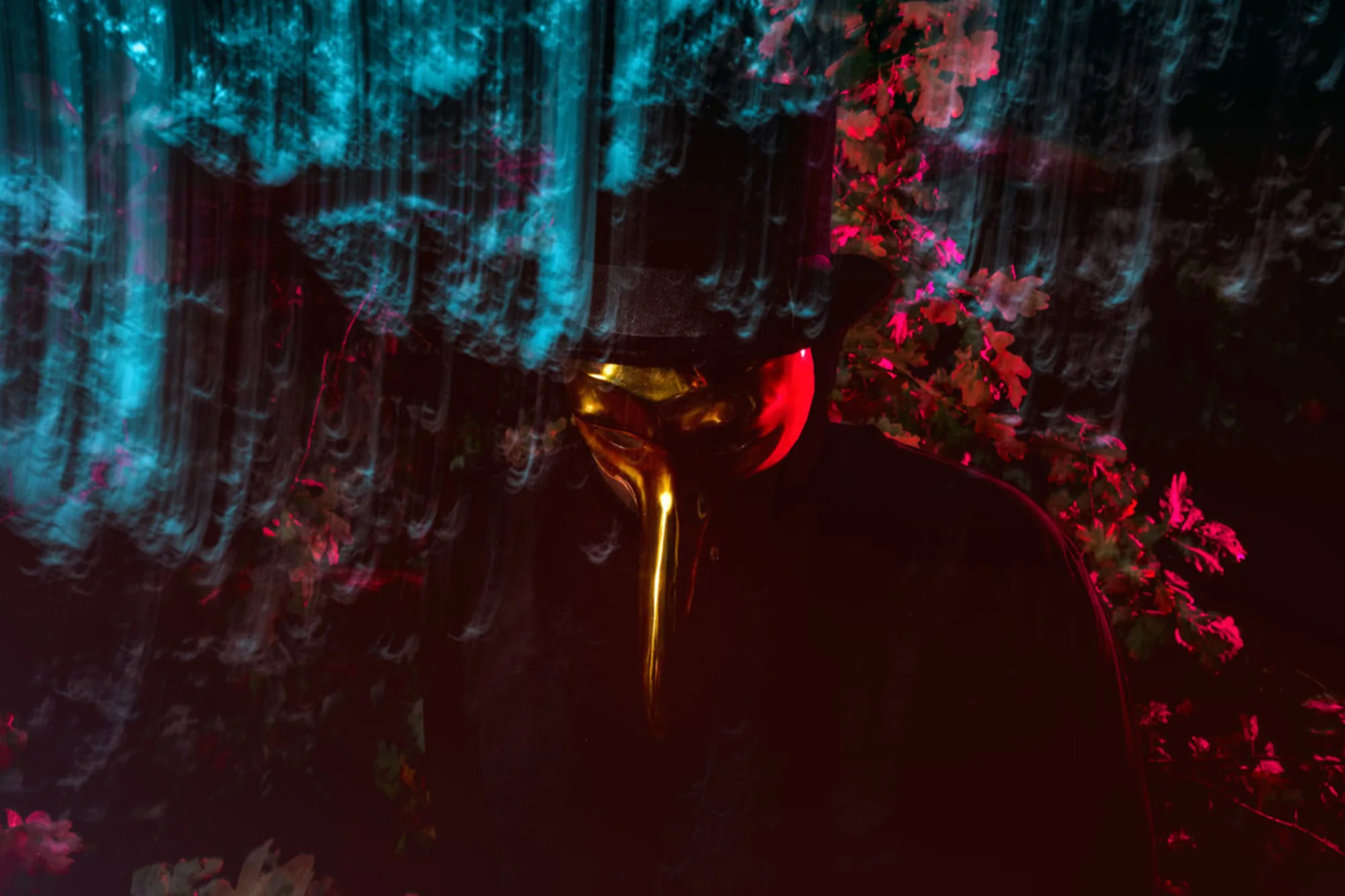 Claptone against a neon-lit forest, golden mask in profile