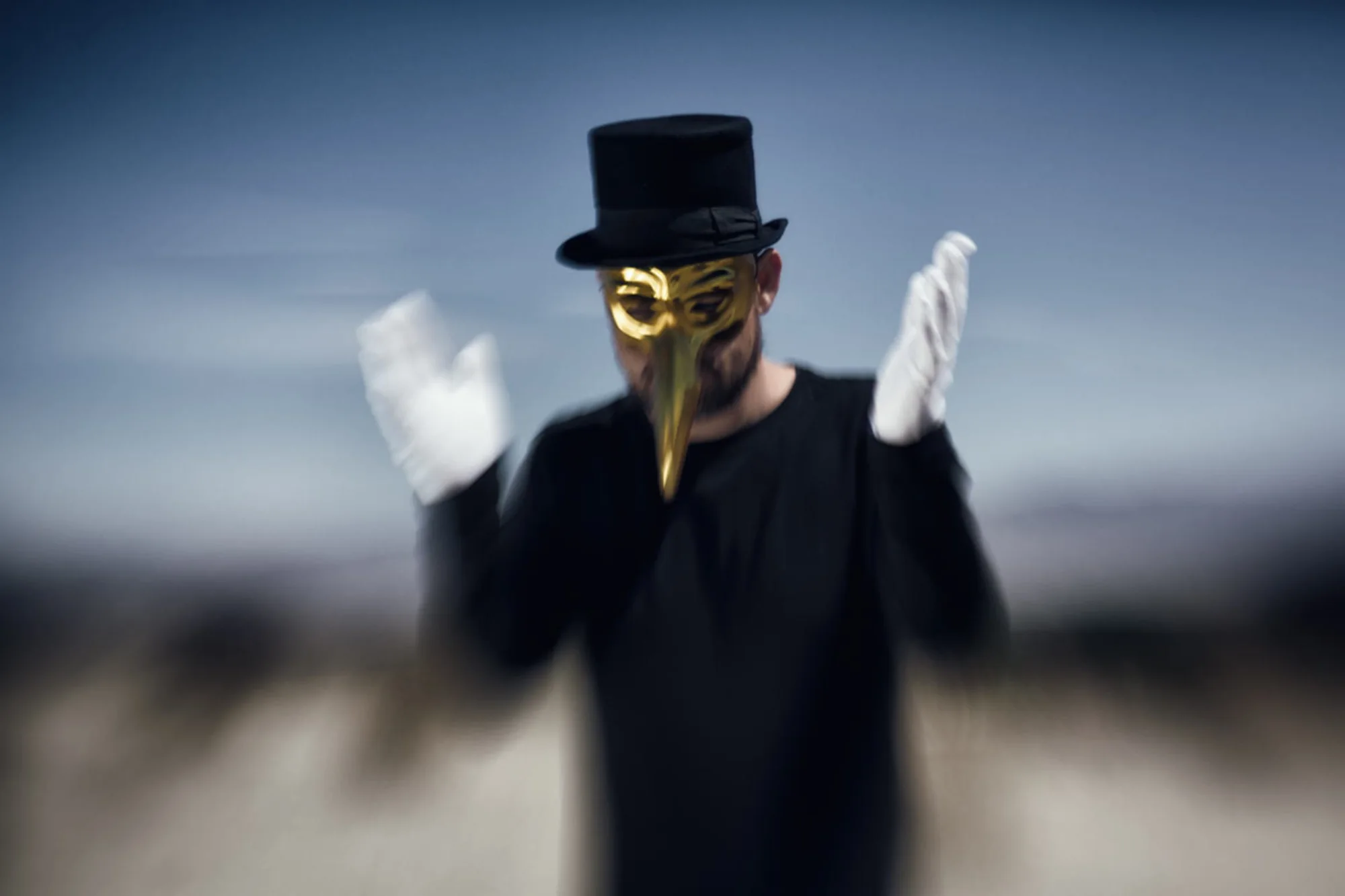 Claptone clapping in white gloves, the background blurred